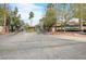 View of the Sunrise Villas community guard-gated entrance with mature desert landscaping at 3422 Pino Cir, Las Vegas, NV 89121