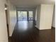 Open-concept living room with dark wood floors, a fireplace, and sliding glass doors to the outside at 3422 Pino Cir, Las Vegas, NV 89121
