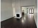 Spacious living room with dark wood floors, a fireplace, and views into the kitchen at 3422 Pino Cir, Las Vegas, NV 89121