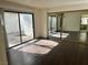 Primary bedroom with mirrored closet, sliding glass door access, and dark wood floors at 3422 Pino Cir, Las Vegas, NV 89121