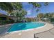Community pool surrounded by mature trees, lounge chairs and desert landscaping at 3422 Pino Cir, Las Vegas, NV 89121