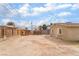 Wide angle of the backyard with dirt landscaping and a shed at 3704 Haddock Ave, North Las Vegas, NV 89030