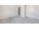 This is a carpeted bedroom with neutral colors and an adjacent doorway at 3704 Haddock Ave, North Las Vegas, NV 89030