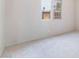 Cozy bedroom with neutral carpet and a window overlooking the backyard, offering a serene retreat at 3704 Haddock Ave, North Las Vegas, NV 89030