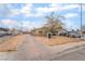 Modest single-story home features a long driveway, desert landscaping, and mature trees at 3704 Haddock Ave, North Las Vegas, NV 89030