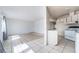 Bright living room with tile floors, white walls, and natural light; open to the kitchen, perfect for entertaining at 3704 Haddock Ave, North Las Vegas, NV 89030