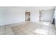 Spacious living area with tile flooring and natural light, seamlessly connected to the kitchen at 3704 Haddock Ave, North Las Vegas, NV 89030