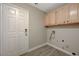 Functional laundry room with overhead cabinets and convenient access to exterior at 371 Sanctuary Ct, Henderson, NV 89014