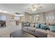 Open living room with bar area and kitchen, featuring a large sectional sofa and natural light at 371 Sanctuary Ct, Henderson, NV 89014