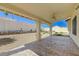 View of the covered patio with stone flooring and ample space for outdoor seating at 371 Sanctuary Ct, Henderson, NV 89014