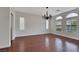 The dining room features wood floors, a chandelier, and windows covered in white shutters at 3728 White Lion Ln, North Las Vegas, NV 89084