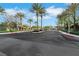 Community entrance with palm trees, landscaped median and street at 3728 White Lion Ln, North Las Vegas, NV 89084