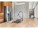 Close up of the kitchen featuring stainless steel refrigerator, granite countertops, and stainless faucet at 4624 Leon De Oro Dr, Las Vegas, NV 89129