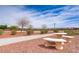 Park featuring walking path, gravel landscaping, and picnic tables on a sunny day at 4624 Leon De Oro Dr, Las Vegas, NV 89129