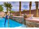 The gorgeous pool has a stacked stone waterfall feature with decorative planters and mature landscaping at 4624 Leon De Oro Dr, Las Vegas, NV 89129