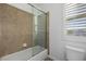 Bathroom featuring a glass shower, tile surround, and neutral color palette at 537 Blanche Ct, Henderson, NV 89052