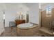 Bright bathroom featuring dual sinks, a walk-in shower, and a large soaking tub at 537 Blanche Ct, Henderson, NV 89052