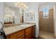 Bright bathroom featuring granite countertops, wood cabinets, and a walk-in shower at 537 Blanche Ct, Henderson, NV 89052