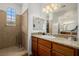 Bright bathroom featuring granite countertops, wood cabinets, and a walk-in shower at 537 Blanche Ct, Henderson, NV 89052