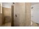 Shower featuring neutral tile, glass-block window, and a doorway to the rest of the bathroom at 537 Blanche Ct, Henderson, NV 89052