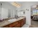 Bathroom featuring a dual-sink vanity with granite countertops and warm lighting at 537 Blanche Ct, Henderson, NV 89052
