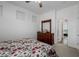 Bedroom with a wooden dresser and mirror; neutral walls and carpet flooring and natural light at 537 Blanche Ct, Henderson, NV 89052