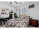Bright bedroom featuring a floral-patterned bed, window shutters, and a closet with organizers at 537 Blanche Ct, Henderson, NV 89052