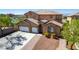 Lovely two story home with a three car garage, desert landscaping, and brick paver accents on the driveway at 537 Blanche Ct, Henderson, NV 89052
