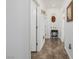 Well-lit hallway featuring unique decor and tiled flooring at 537 Blanche Ct, Henderson, NV 89052