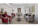 A formal living room featuring designer furniture, plush carpeting, and elegant decor with white walls at 537 Blanche Ct, Henderson, NV 89052
