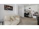 Cozy living room with comfortable seating, neutral carpet and an arched entry to an office space at 537 Blanche Ct, Henderson, NV 89052