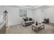 Cozy living room with grey sofa, white walls, neutral carpet and natural light from the shuttered window at 537 Blanche Ct, Henderson, NV 89052