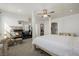 Bright bedroom with a four-poster bed, ceiling fan, and a fireplace feature at 537 Blanche Ct, Henderson, NV 89052