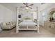 Bright bedroom with a four-poster bed, ceiling fan, carpeted floors, and a dresser at 537 Blanche Ct, Henderson, NV 89052