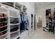 Bright walk-in closet with custom shelving, rods, and shoe racks at 537 Blanche Ct, Henderson, NV 89052