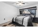 Bedroom featuring a large bed with grey and black linens, bedside tables, and a ceiling fan at 5710 E Tropicana Ave # 1166, Las Vegas, NV 89122