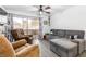 Bright living room boasts wood-look tile floors, ceiling fan, and sliding glass doors to a patio at 5710 E Tropicana Ave # 1166, Las Vegas, NV 89122