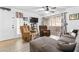 Cozy living room with wood-look tile floors, ceiling fan, sliding glass doors, and comfortable furniture at 5710 E Tropicana Ave # 1166, Las Vegas, NV 89122