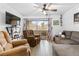 Comfortable living room featuring tile floors, a ceiling fan, and a sliding glass door to the outside at 5710 E Tropicana Ave # 1166, Las Vegas, NV 89122