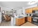 Open floor plan with a view from the kitchen into a brightly lit living space with sliding glass doors at 5710 E Tropicana Ave # 1166, Las Vegas, NV 89122