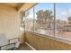 Enclosed patio with relaxing chair and views of the community's landscaping and covered parking at 5710 E Tropicana Ave # 1166, Las Vegas, NV 89122