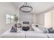 Bright living room features a modern fireplace, elegant light fixture, and comfortable white sectional sofa at 5750 Edna Ave, Las Vegas, NV 89146