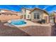 Backyard view of the pool surrounded by a tan concrete path at 5861 Lakeland Village Dr, North Las Vegas, NV 89081