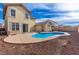 Backyard with a pool and tan concrete walkway leading to the home at 5861 Lakeland Village Dr, North Las Vegas, NV 89081