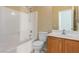 Bathroom featuring a tub-shower combo, toilet, and vanity with oak cabinets at 5861 Lakeland Village Dr, North Las Vegas, NV 89081