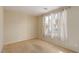Neutral carpeted bedroom features natural light from a large window with curtains and a smooth wall at 5861 Lakeland Village Dr, North Las Vegas, NV 89081