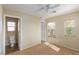 Bedroom with carpet, ceiling fan, and two windows providing ample natural light at 5861 Lakeland Village Dr, North Las Vegas, NV 89081