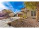 A lovely two-story home with a spacious driveway and drought-resistant landscaping, perfect for low-maintenance living at 5861 Lakeland Village Dr, North Las Vegas, NV 89081