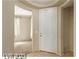 Inviting entryway with white door and trim, neutral walls and flooring, and a glimpse into adjoining spaces at 5861 Lakeland Village Dr, North Las Vegas, NV 89081