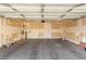 Spacious two-car garage is unfinished, ready for customization and organization at 5861 Lakeland Village Dr, North Las Vegas, NV 89081